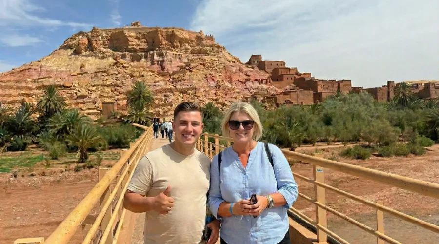 ait-ben-haddou-bridge-tourists-marrakech-day-trip Tourists standing on the bridge at Ait Ben Haddou during a day trip from Marrakech