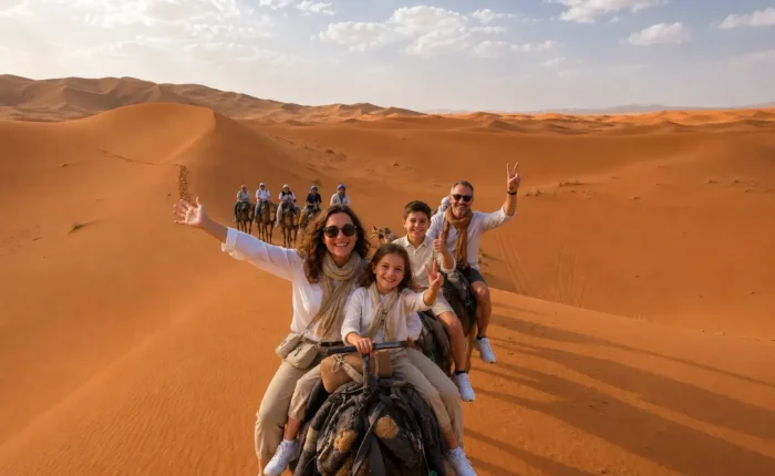 Family enjoying camel trekking in the Merzouga Sahara desert during the 7 days Marrakech to Fes desert tour