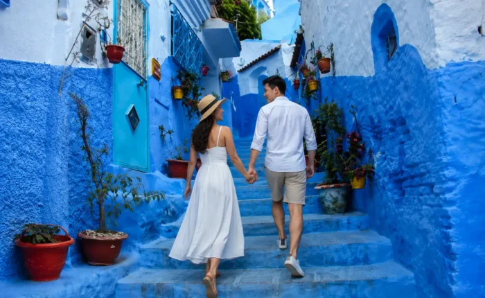 Chefchaouen Day Trip from Fes, Couple walking through the blue streets of Chefchaouen during a day trip from Fes Morocco