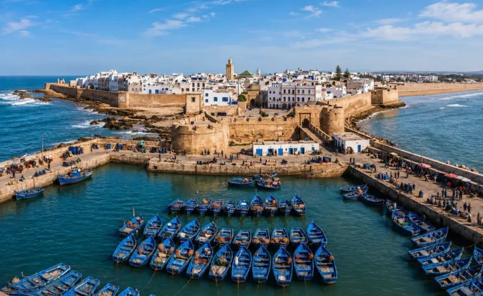 Panoramic view of Essaouira medina and blue fishing boats during a day trip from Marrakech