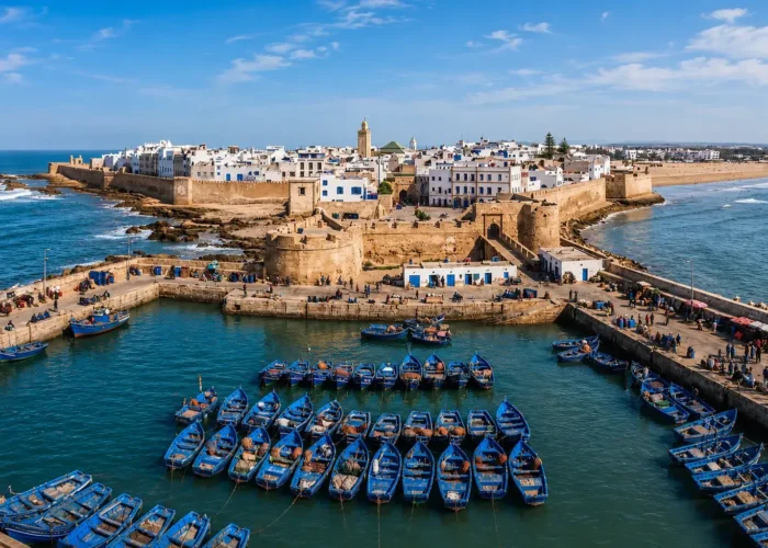 Panoramic view of Essaouira medina and blue fishing boats during a day trip from Marrakech