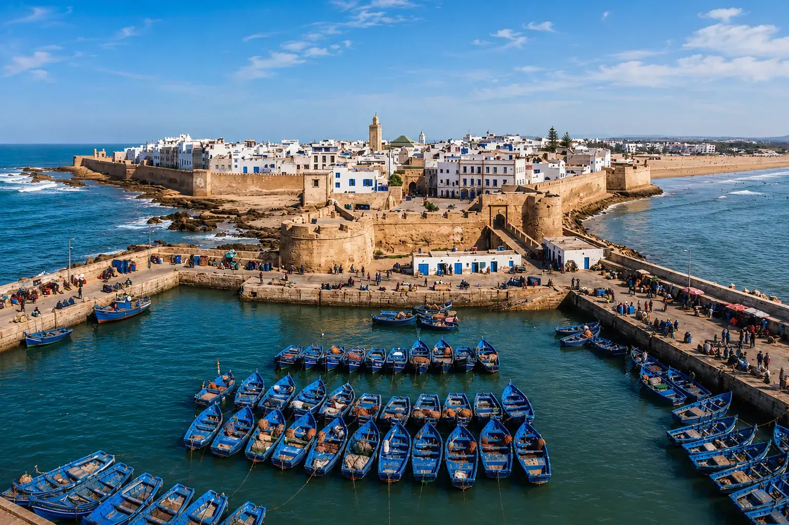 Panoramic view of Essaouira medina and blue fishing boats during a day trip from Marrakech